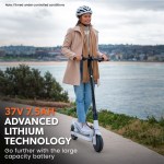 valk 400w electric scooter, with suspension for adults portable folding ride on,synergy 5 mkii white Person riding electric scooter by the water.
