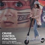 valk 400w electric scooter, with suspension for adults portable folding ride on,synergy 5 mkii white Person rides scooter past street art mural.
