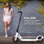 valk synergy 7 mkii electric scooter 500w 15ah, motorised escooter for adults, white Woman with electric scooter against ivy-covered wall.