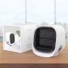 Compact white air cooler on wooden surface.