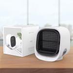 Compact white air cooler on wooden surface.
