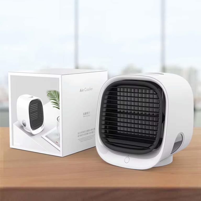 Compact white air cooler on wooden surface.