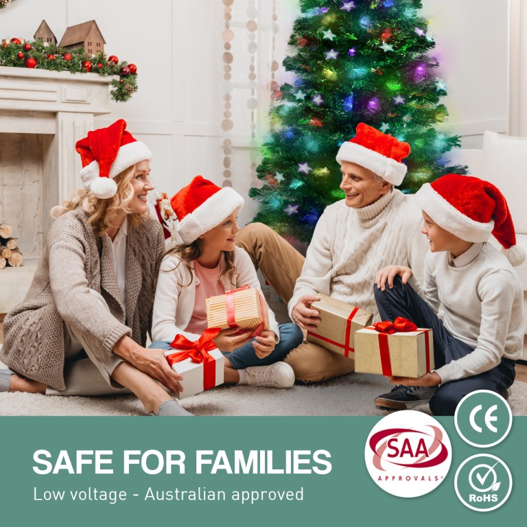 Family in Santa hats exchanging Christmas gifts.