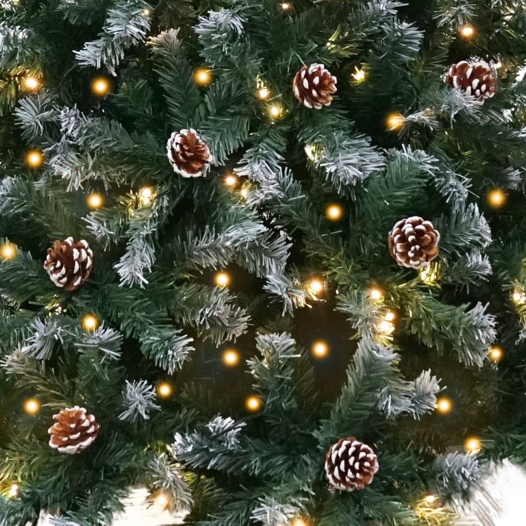 Christmas tree with lights and pinecones.