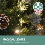 Christmas tree with warm LED lights and pinecone.