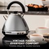Modern kettle in stylish kitchen with teacups.