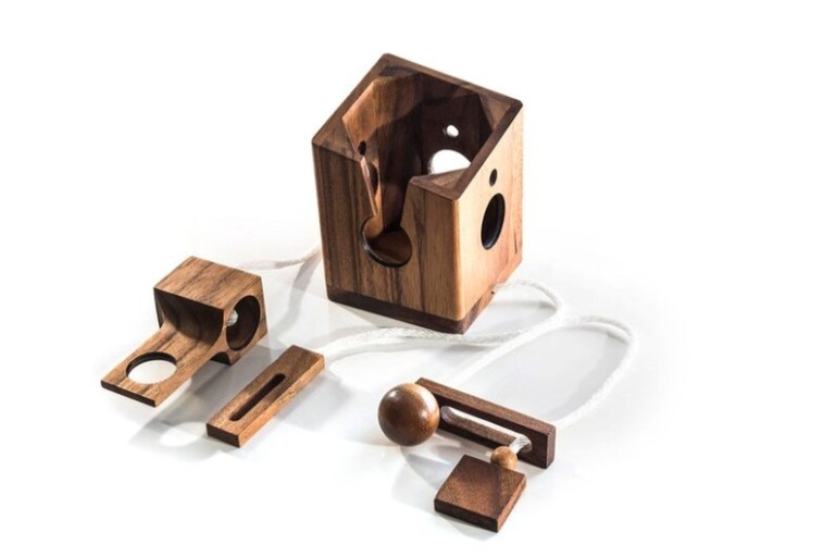 Wooden puzzle pieces with rope and ball