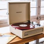 crosley voyager bluetooth portable turntable dune + bundled crosley record storage display stand Portable turntable playing red vinyl record indoors