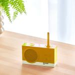 Yellow retro radio on wooden table.