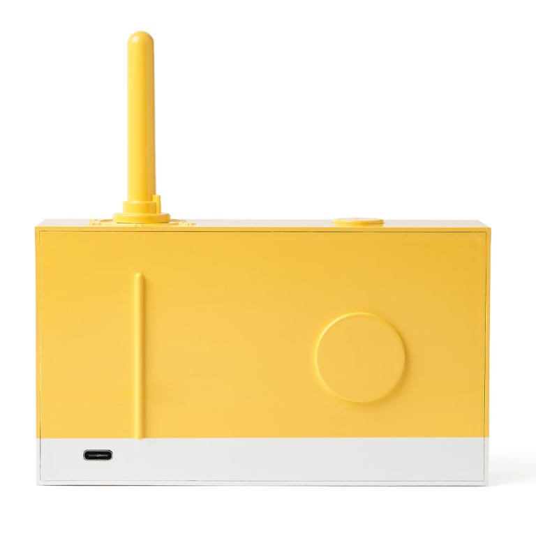 Yellow retro radio with antenna, white base.