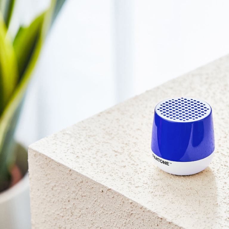lexon mino+ mini bluetooth speaker pantone classic blue Blue portable speaker on textured white surface.
