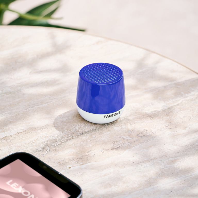 lexon mino+ mini bluetooth speaker pantone classic blue Blue Pantone speaker on marble table, smartphone nearby