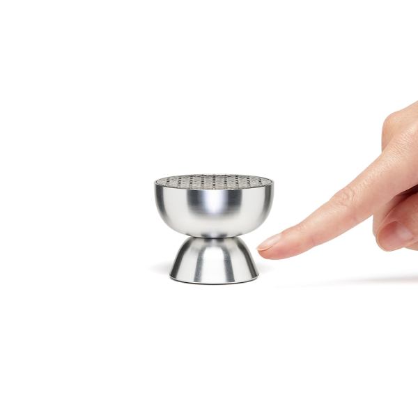 lexon tamo infinitely pairable bluetooth speaker alu polish Metal ant moai sculpture next to finger for scale.