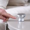 lexon tamo infinitely pairable bluetooth speaker alu polish Finger touching small metallic speaker on table.