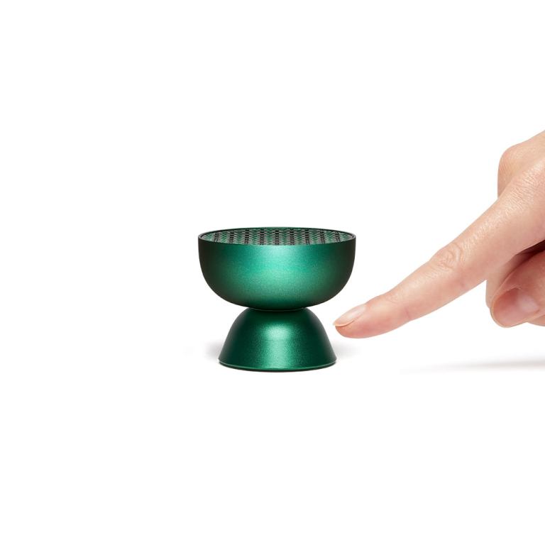 lexon tamo infinitely pairable bluetooth speaker green Green incense burner with fingertip beside it.