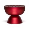 Red modern speaker with perforated top design.