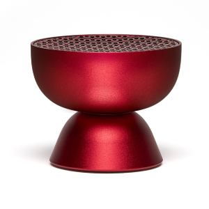 Red modern speaker with perforated top design.