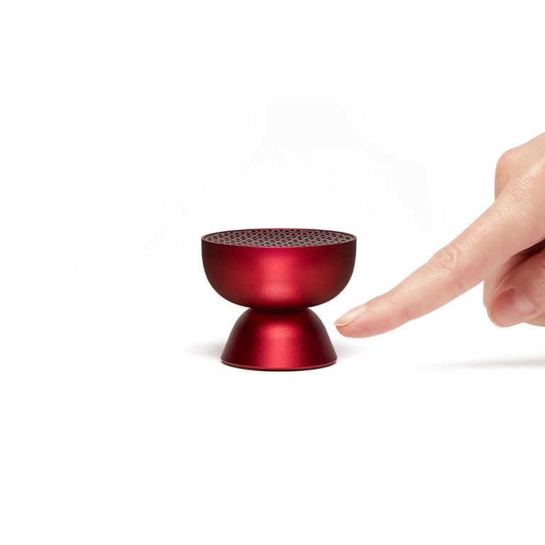 lexon tamo infinitely pairable bluetooth speaker red Finger touching compact red wireless speaker.