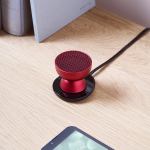lexon tamo infinitely pairable bluetooth speaker red Red portable speaker on wooden desk.