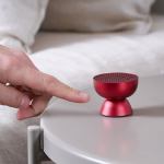 lexon tamo infinitely pairable bluetooth speaker red Finger pointing at small red speaker on table.
