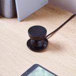 lexon tamo infinitely pairable bluetooth speaker black Compact black desk speaker on wooden surface