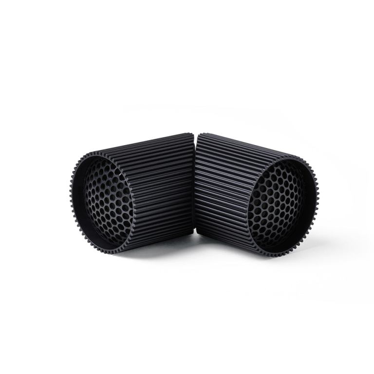 Black cylindrical brush connectors on white background.