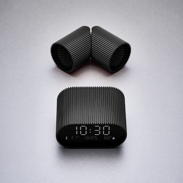 Modern black digital clock on grey background.