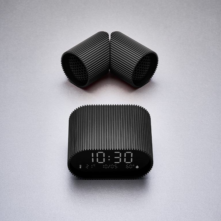 Modern black digital clock on grey background.