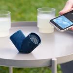 lexon ray set of magnetic bluetooth speakers blue Bluetooth speaker and smartphone on outdoor table