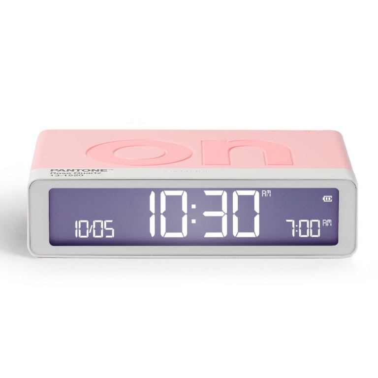 lexon gift set pantone includes mino+ mini speaker, flip classic clock, mina m lamp, thykho 3 speaker rose pink Pink digital alarm clock displaying 10:30 AM.