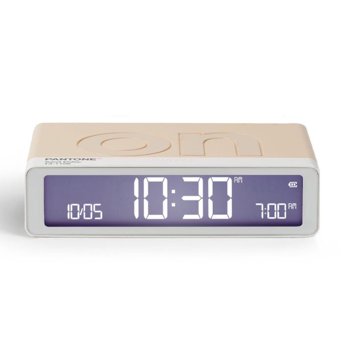 lexon gift set pantone includes mino+ mini speaker, flip classic clock, mina m lamp, thykho 3 speaker sand Digital clock displaying 10:30 AM with beige casing.
