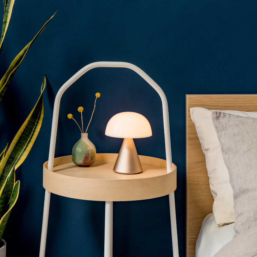 Bedside table with lamp and vase
