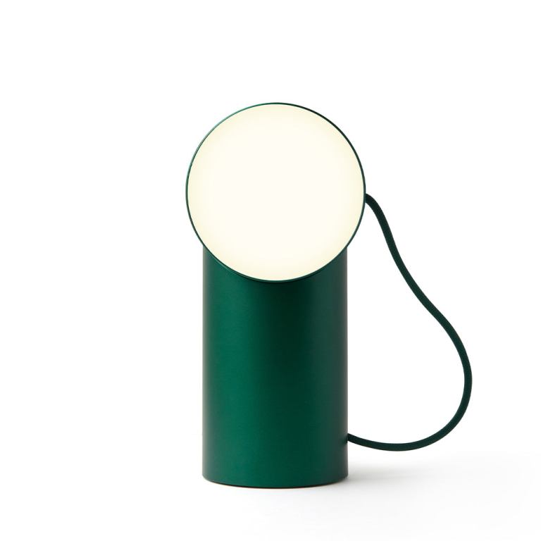 Modern green cylindrical table lamp with cord.