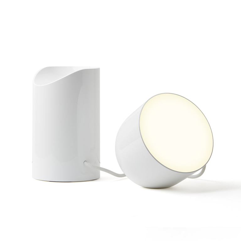 lexon orbe portable led lamp with moving head white Modern white lamp with cylindrical base and diffuser.