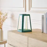 Modern triangular teal lamp on wooden cabinet.