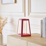 Modern red table lamp on wooden surface