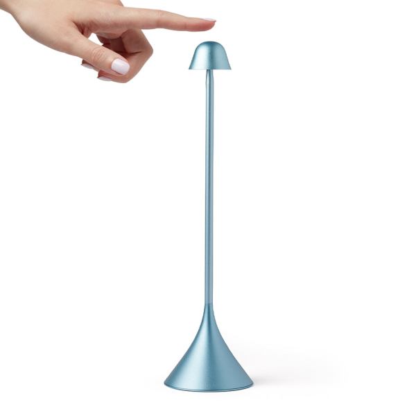Hand about to touch blue touch lamp.