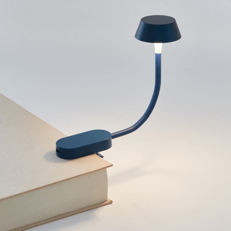 lexon mimi flexible led lamp dark blue Clip-on book reading light on hardcover book.