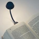 lexon mimi flexible led lamp dark blue Book illuminated by a flexible reading lamp.