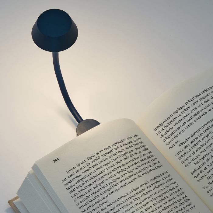 lexon mimi flexible led lamp dark blue Book illuminated by a flexible reading lamp.