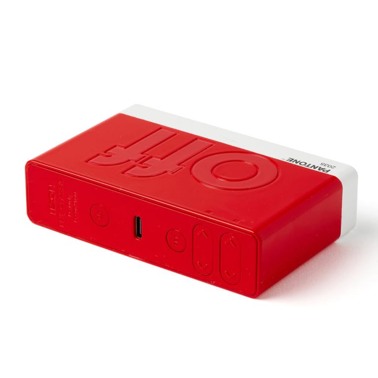 lexon flip classic reversible alarm clock pantone 2035 red Red Pantone USB speaker on white background.