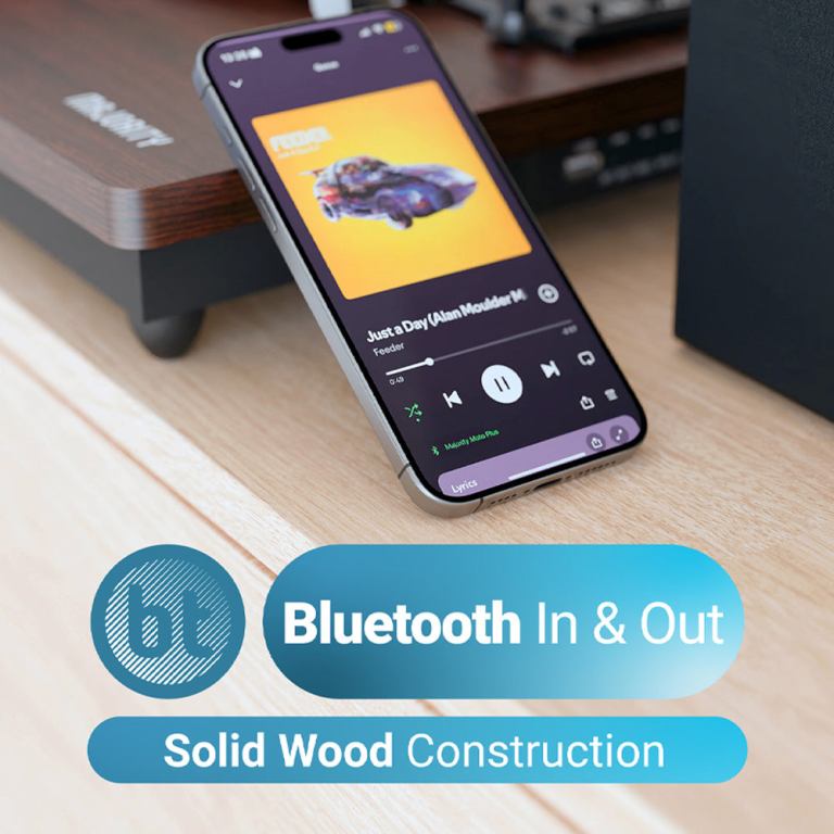 majority moto plus turntable Smartphone with music player on wooden surface.