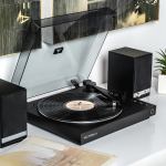 Black record player with two speakers on a desk.