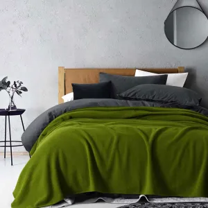 Stylish bedroom with green blanket and modern decor.