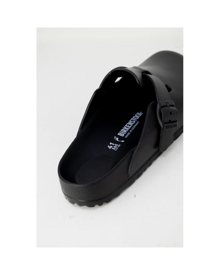 Black Birkenstock clog with buckle detail.