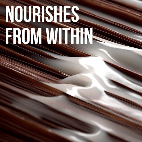 Close-up of conditioner applied to smooth brown hair.