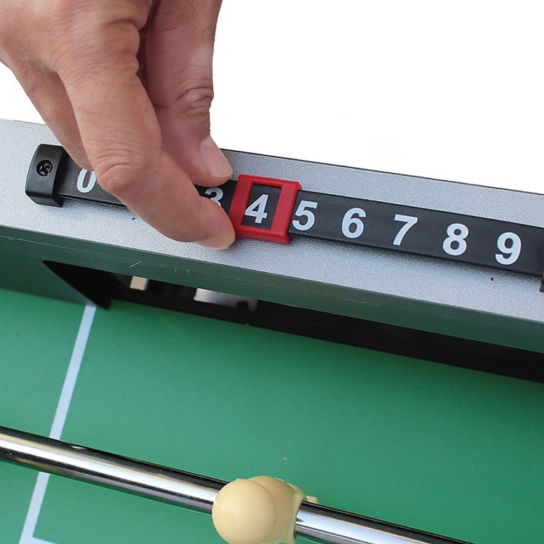 Hand adjusting table tennis score counter.