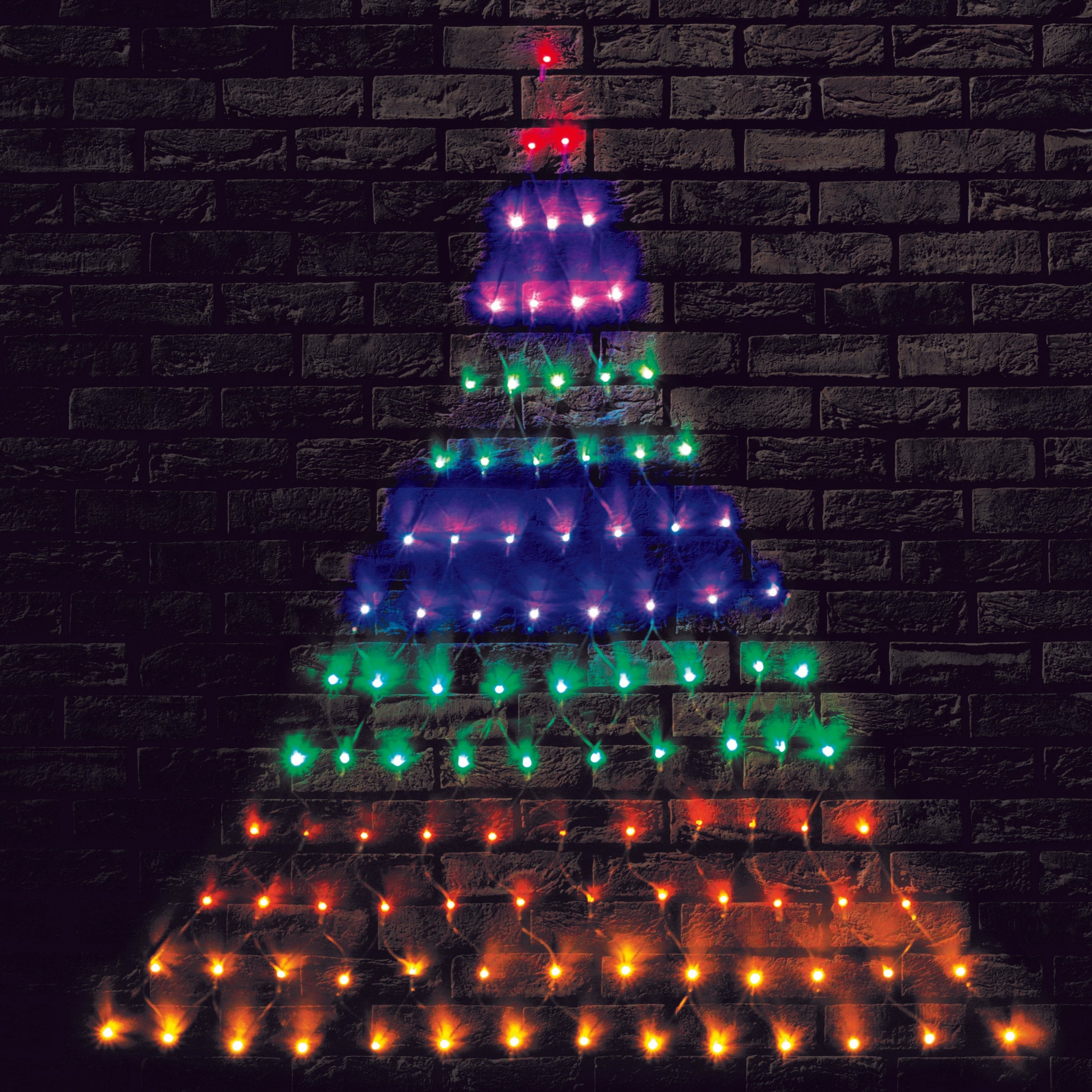 Colourful Christmas tree lights on brick wall