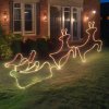 House with glowing reindeer Christmas lights decoration.