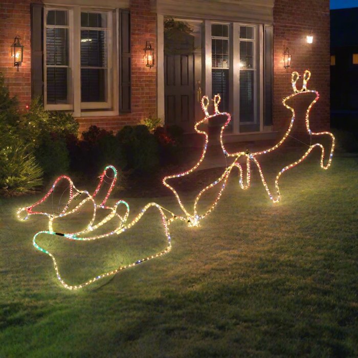 House with glowing reindeer Christmas lights decoration.